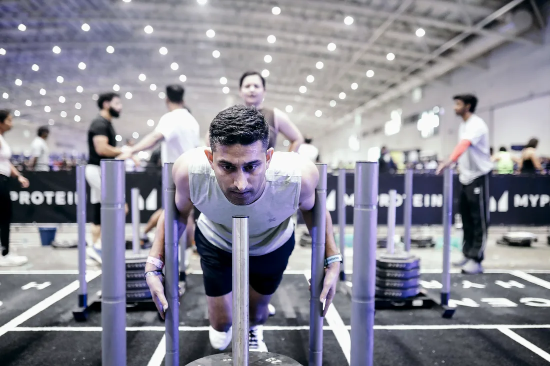 Akshit driving low on the sled push at Hyrox Bengaluru